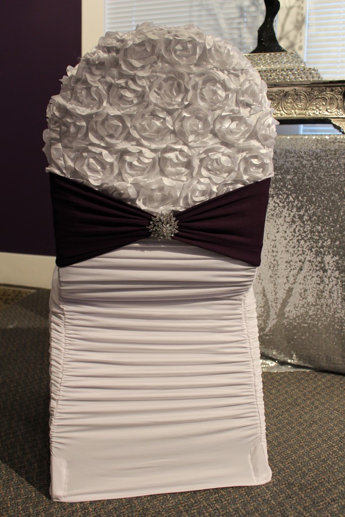 white ruched chair cover with white rosette chair cap and plum chair band
